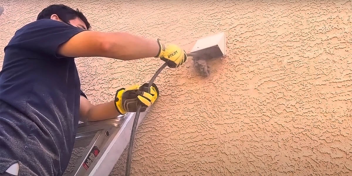 Duct cleaning dryer vent service clearing lint from exterior home vent in Topeka