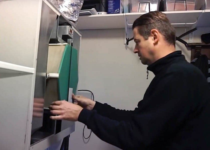 Certified technician installing vent cover during Topeka residential air duct cleaning service